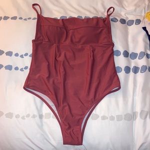 Never worn! Brand new clay covered one piece